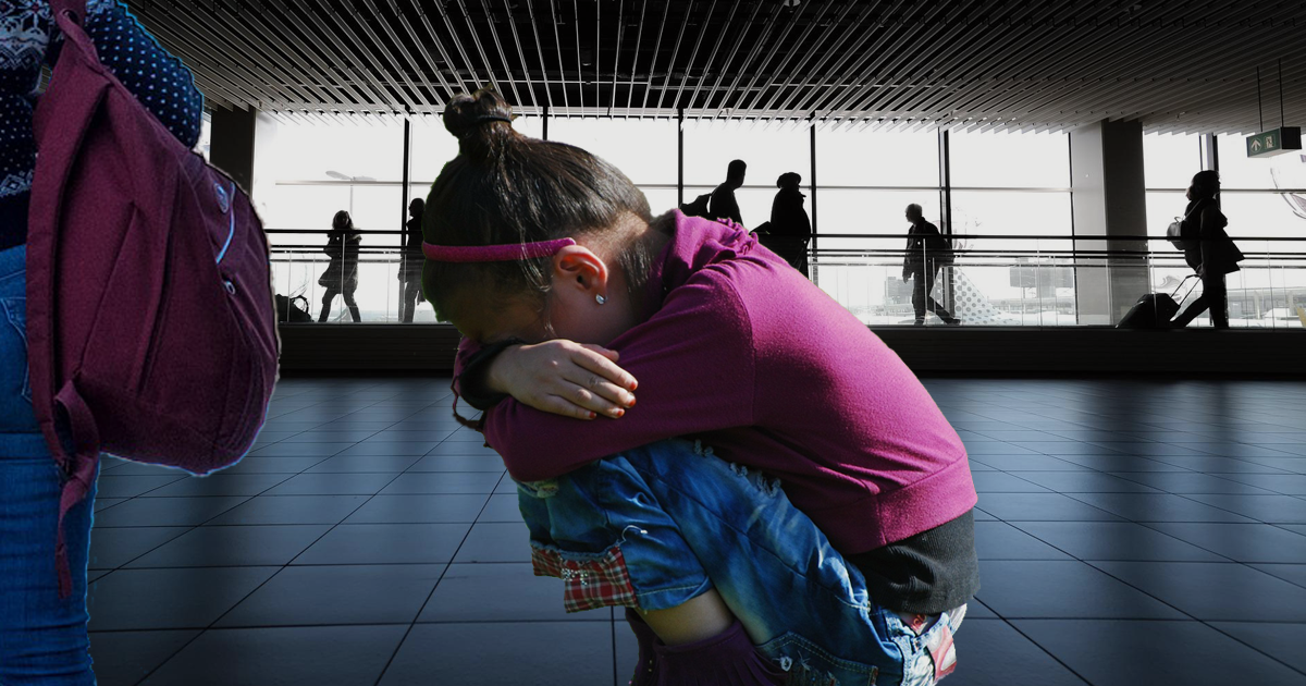 Photo of a 5 year old girl crying with her mom standing next to her. They are outside stuck at the airport unable to fly back home from vacation in Hawaii.
