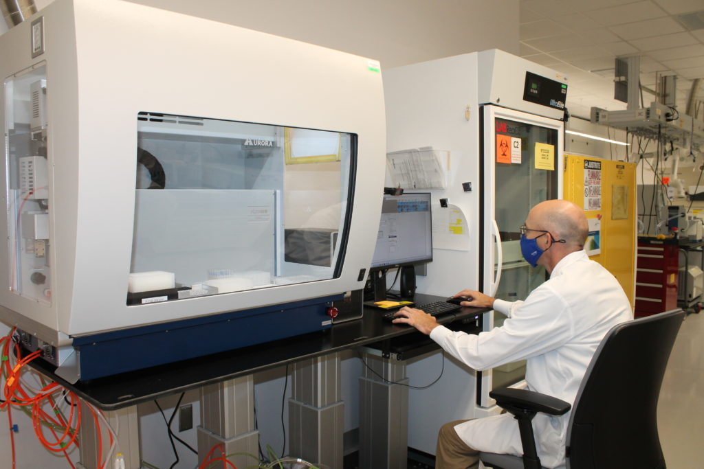 Lab technician operating the VERSA to fully automate peptide purification workflow